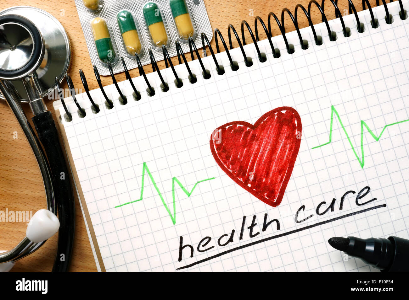 Note with words health care concept on a wooden background. Stock Photo
