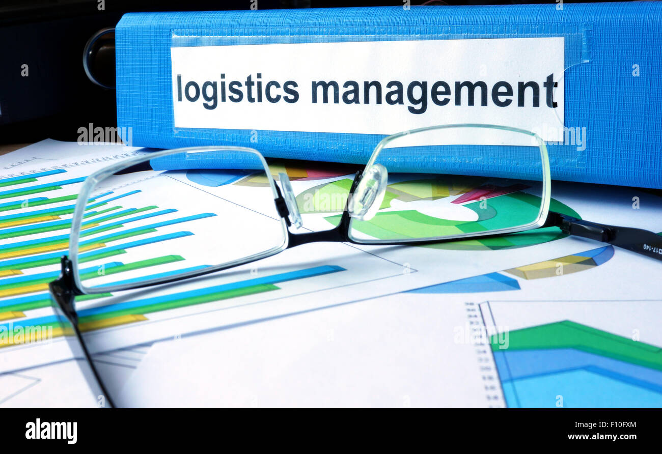 Folder with label logistics management on the office table. Stock Photo