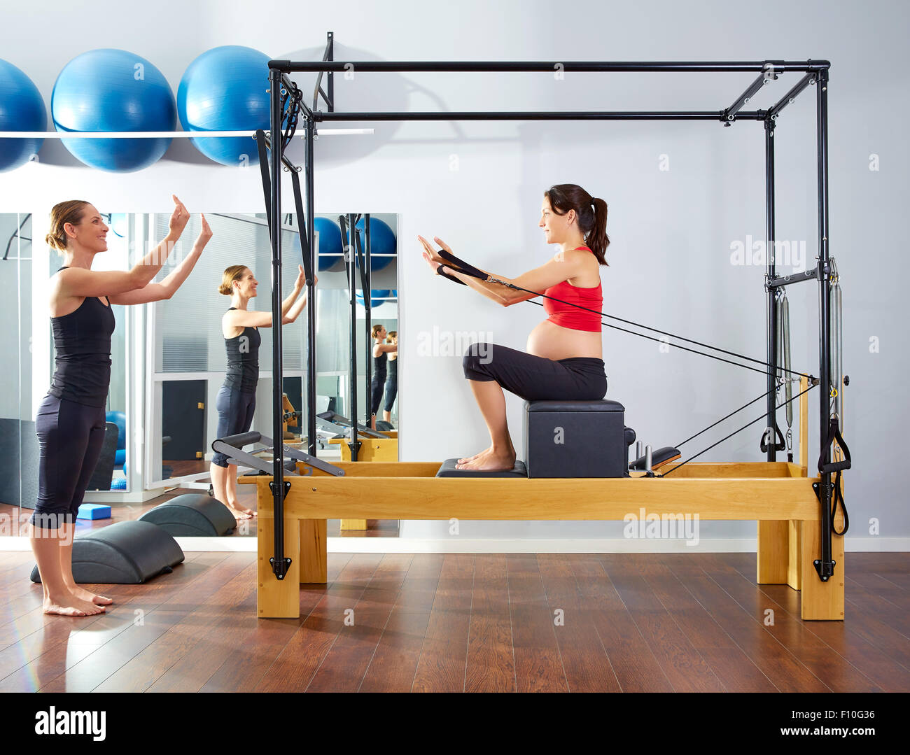 pregnant woman pilates reformer short box exercise workout with