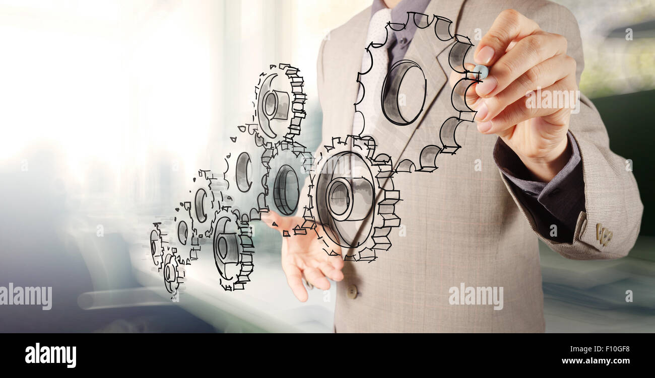 businessman hand draws gear to success concept Stock Photo - Alamy