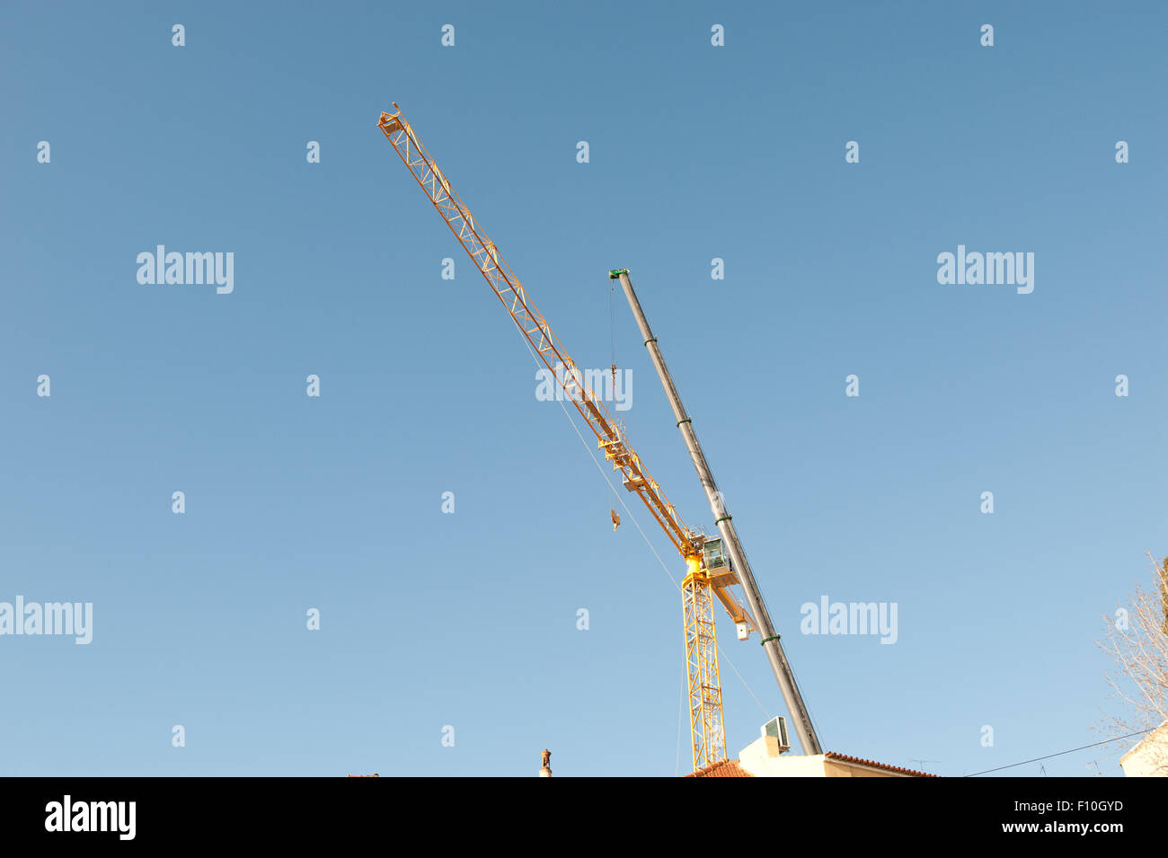 Silhouettes of construction cranes on the sky Stock Photo