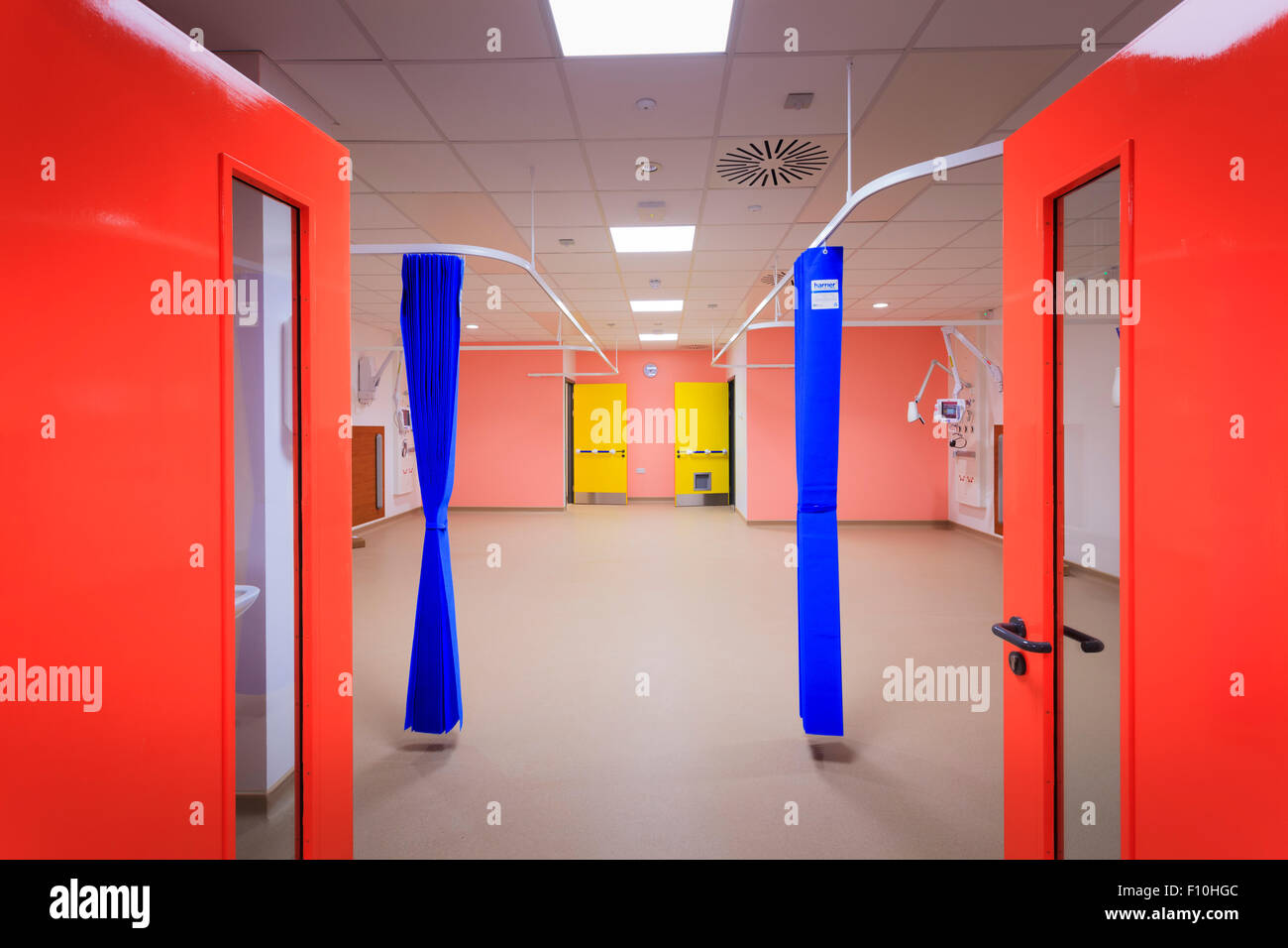 Red double doors leading to empty hospital ward Stock Photo