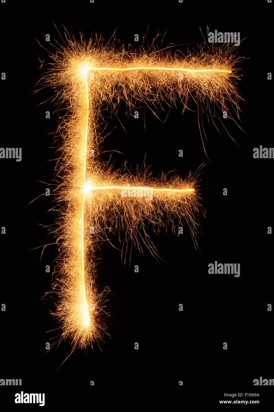 'F' letter drawn with bengali sparkles isolated on black background Stock Photo