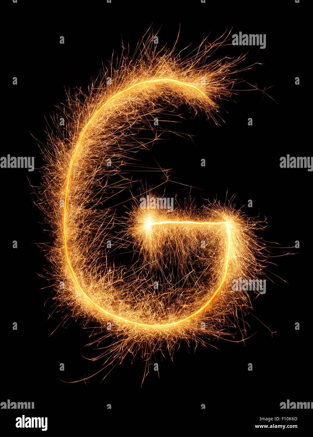 'G' letter drawn with bengali sparkles isolated on black background Stock Photo