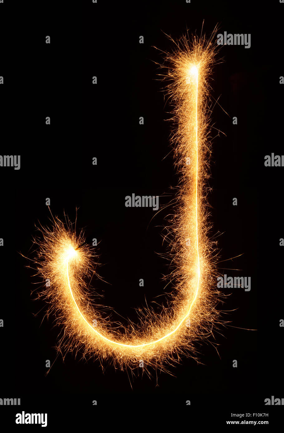 'J' letter drawn with bengali sparkles isolated on black background Stock Photo