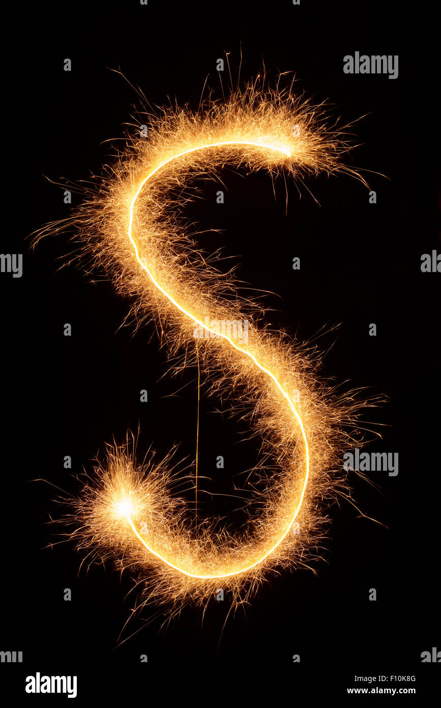 "S" letter drawn with bengali sparkles isolated on black background Stock Photo