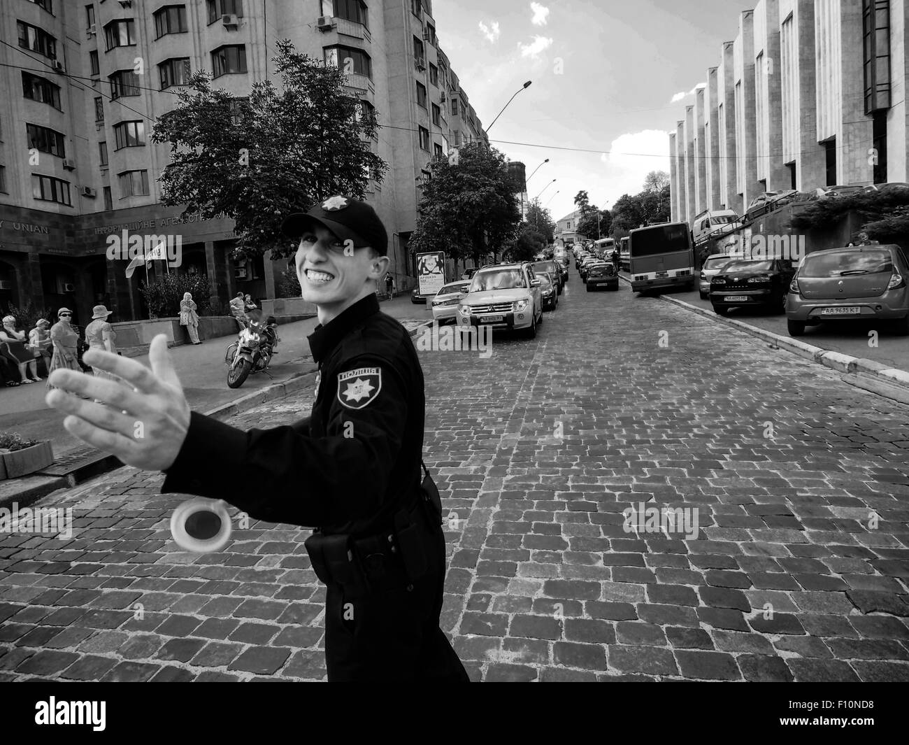 Kiev, Ukraine. 24th Aug, 2015. In place of the usual militia in Ukraine, comes a new police. Uniforms policeman gave the United States. The picture shows a young policeman regulates vehicular traffic in the area of the European Square and Kerschatik. --- Thousands of Ukrainians celebrate the 24 anniversary of Independence of Ukraine mass festivities in towns and villages across the country. This holiday marred by Russian aggression in the east of Ukraine and the occupation of the Crimea. Ukrainians are hoping that 25 Independence Day they will meet in a more peaceful environment. © Igor Golovn Stock Photo
