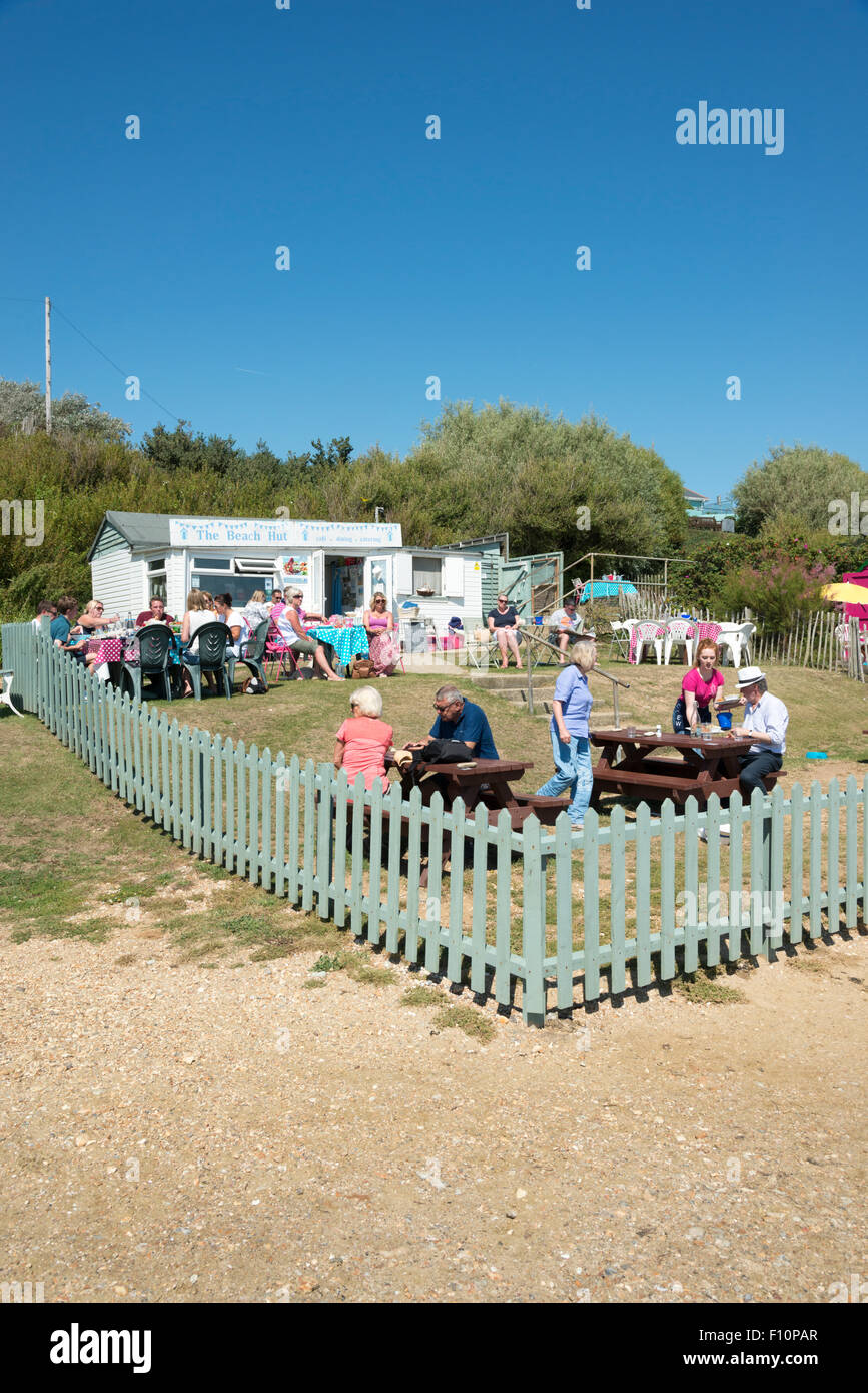 Diners eating outside at the Beach Hut cafe and restaurant on the coast at Bembridge Isle of Wight UK Stock Photo