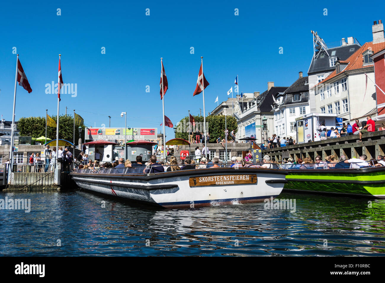 Hotels, restaurants, boats and people on the waterfront district, Nyhavn, Copenhagen, Denmark, Scandinavia, Europe Stock Photo