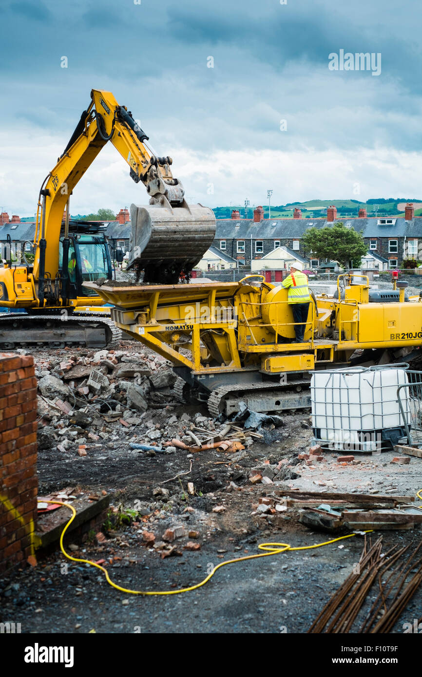 Brownfield site reclamation and redevelopment UK : workers clearing a former industrial site in Aberystwyth in readiness for its use  for a new Tesco  supermarket and a Marks and Spencer store,  Wales UK Stock Photo