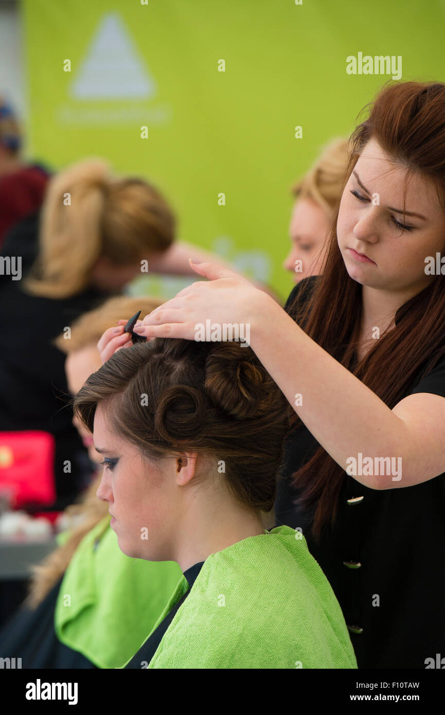 Vocational Education UK: Teenage girls from Coleg Ceredigion competing in the Hairdressing and Beauty vocational training category at the URDD national eisteddfod of Wales, May 2015 Stock Photo