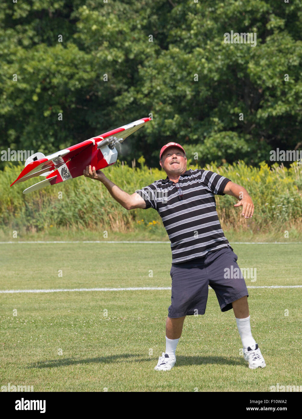 White Lake, Michigan - A member of the Pontiac Miniature Aircraft Club launches a remote-controlled miniature airplane. Stock Photo