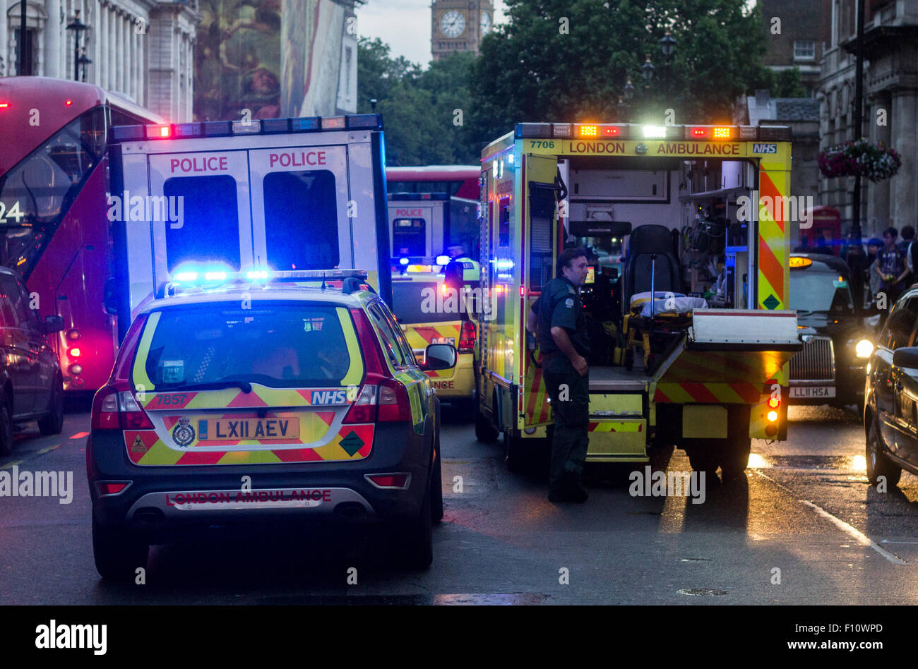 Multiple vehicles on scene of a an injured male in the middle of the road. Stock Photo