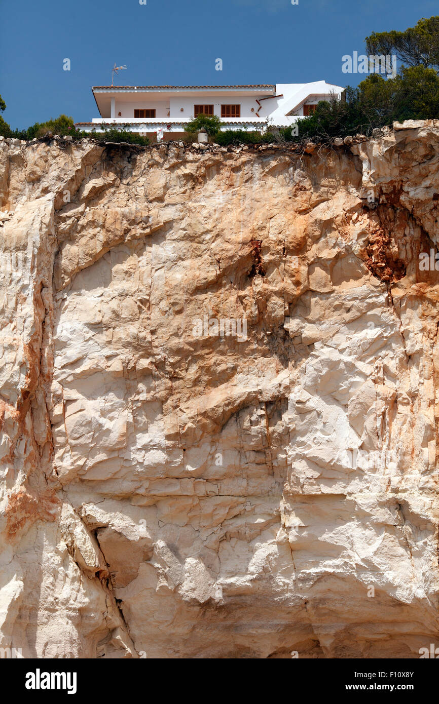 house on the top of eroding cliff Stock Photo