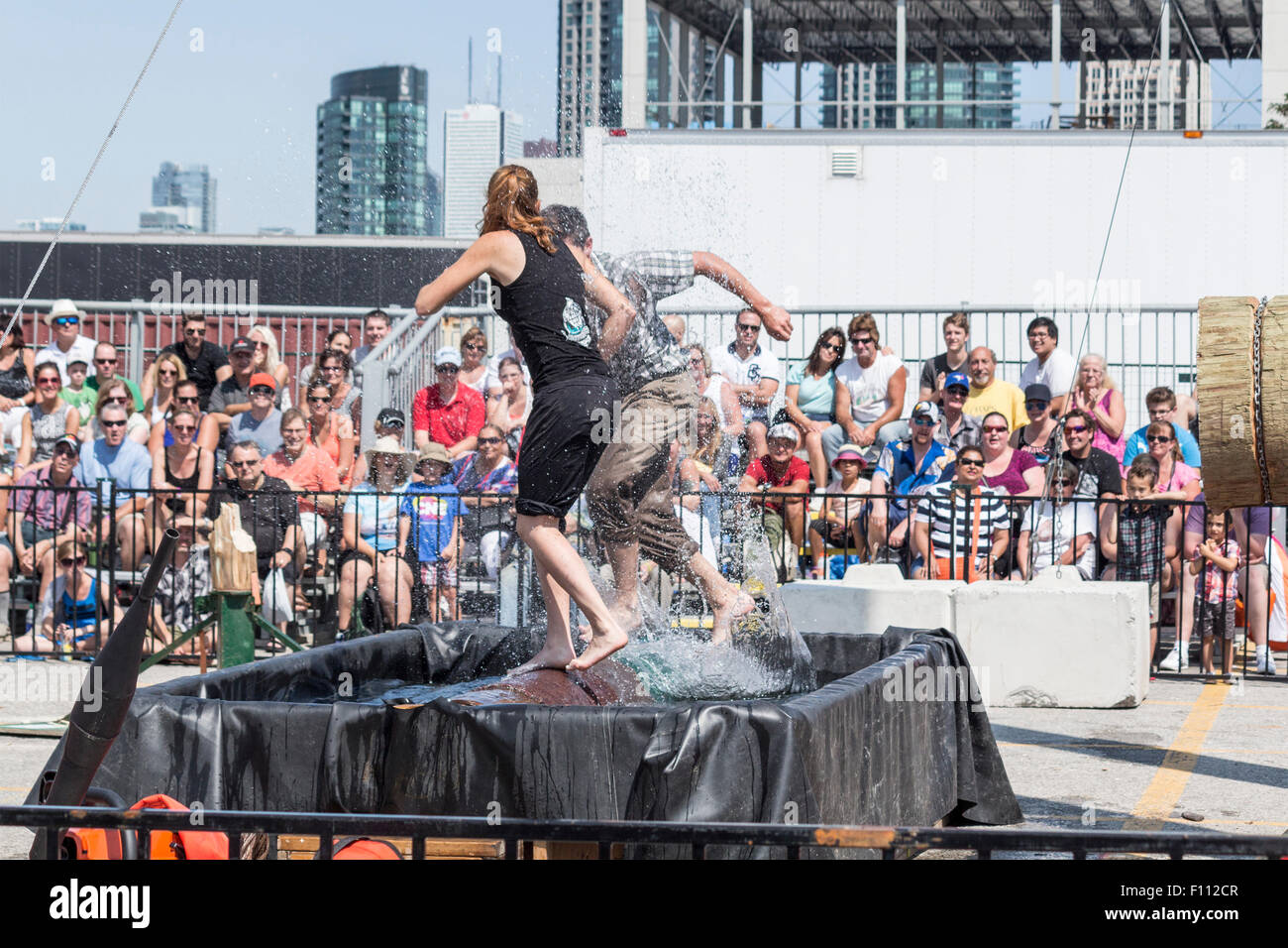 A lumberjack and a lumberjill compete in log rolling competition at the