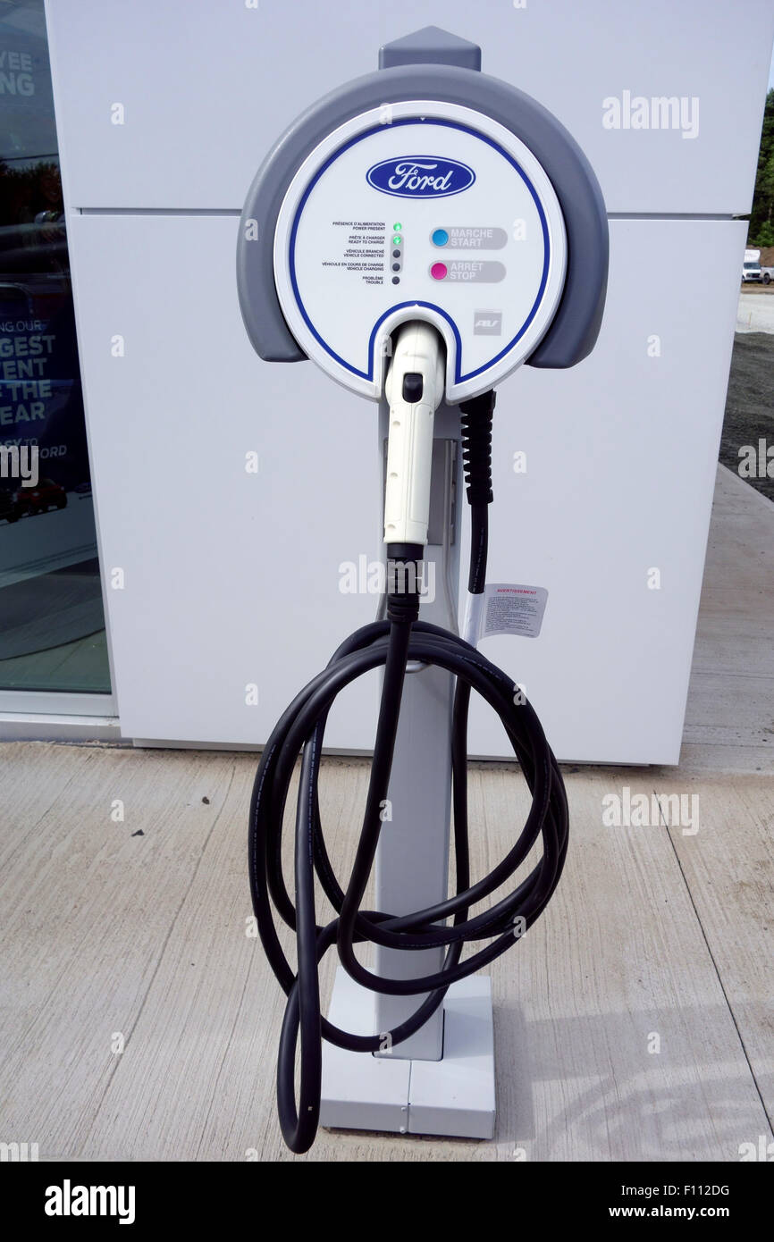 An electric car or vehicle battery charger charging or recharging station at a Ford dealership in Canada Stock Photo