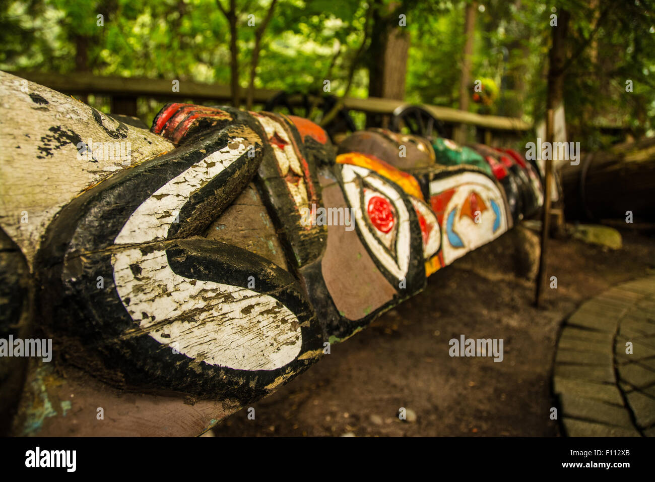This is a fallen totem pole, a legacy of the first nations which is now at the Capilano bridge park in Vancouver, Canada. Stock Photo