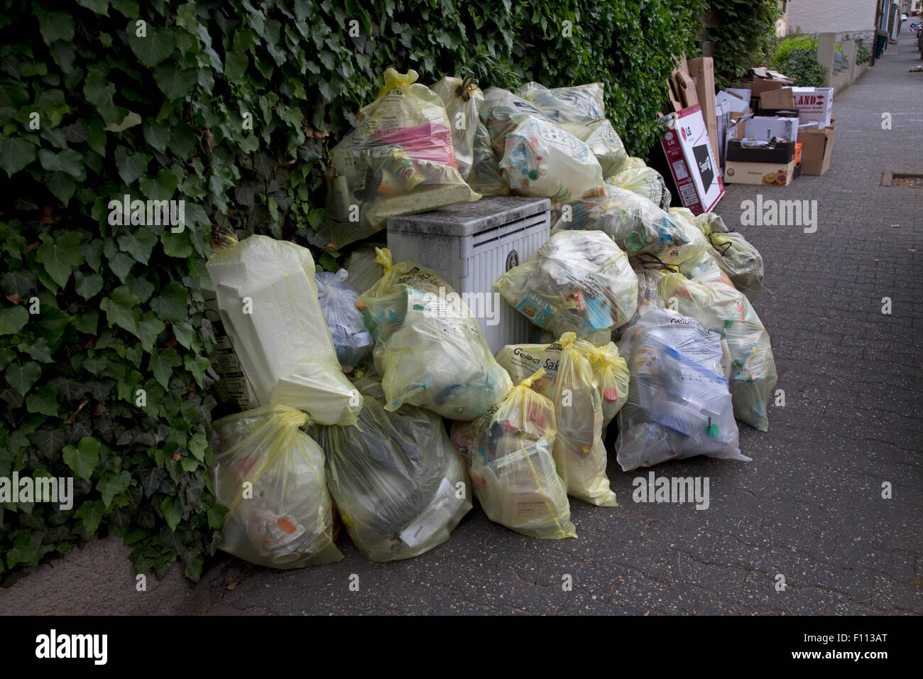 Polythene bags of rubbish on street awaiting collection for recycling