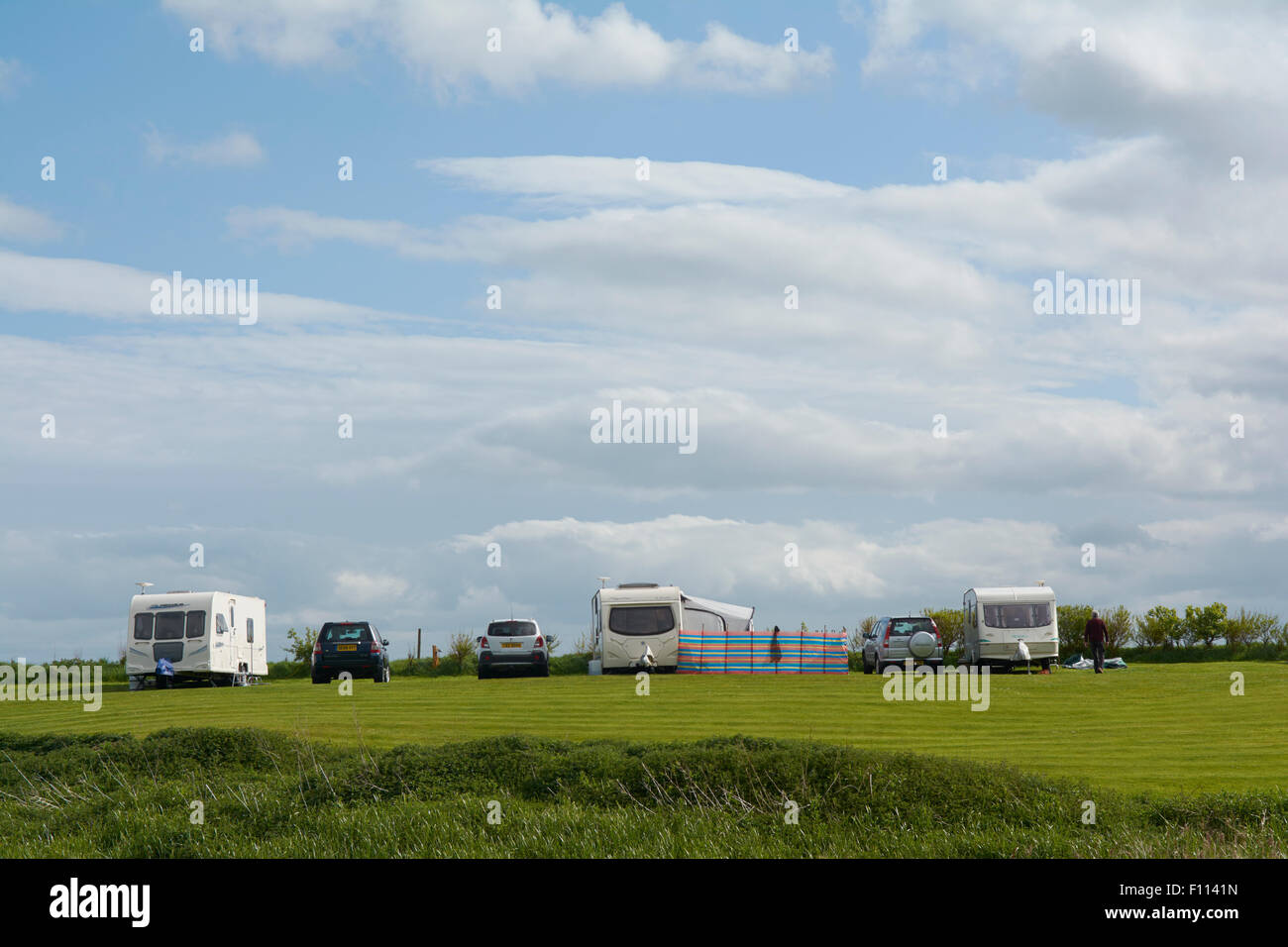 Caravan with Awnings and Motorhome in a field at Fraisethorpe Beach