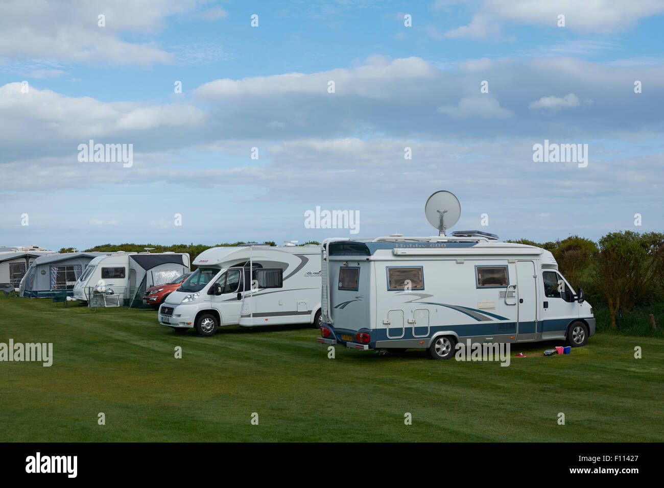 Caravan with Awnings and Motorhome in a field at Fraisethorpe Beach