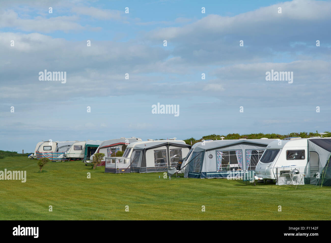 Caravan with Awnings and Motorhome in a field at Fraisethorpe Beach