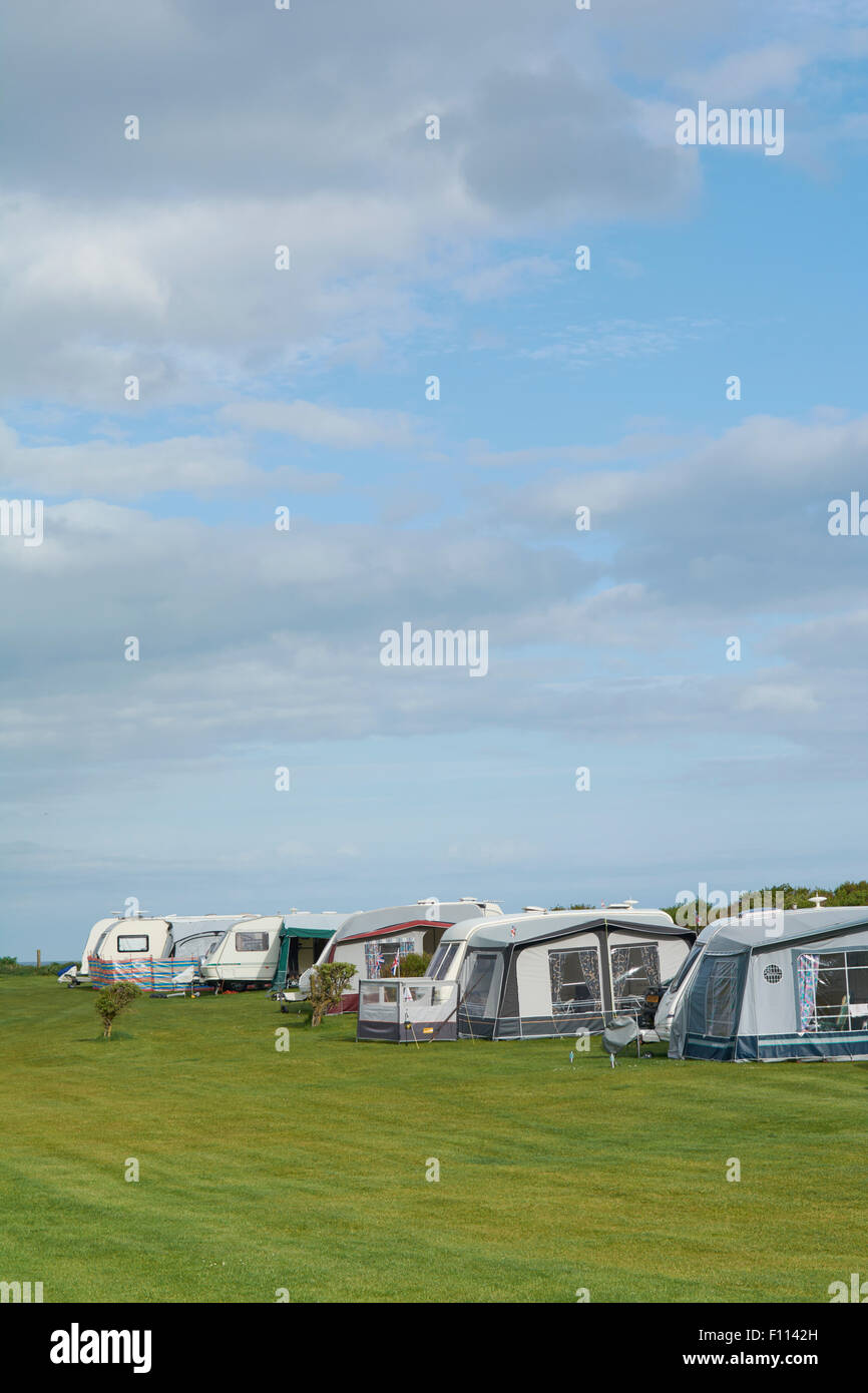Caravan with Awnings and Motorhome in a field at Fraisethorpe Beach