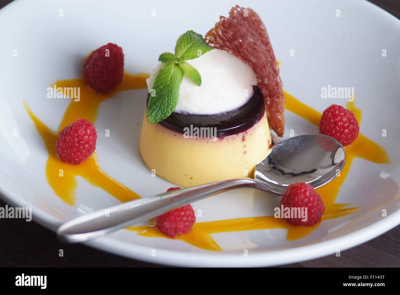 Panna cotta with raspberry coulis Stock Photo Alamy
