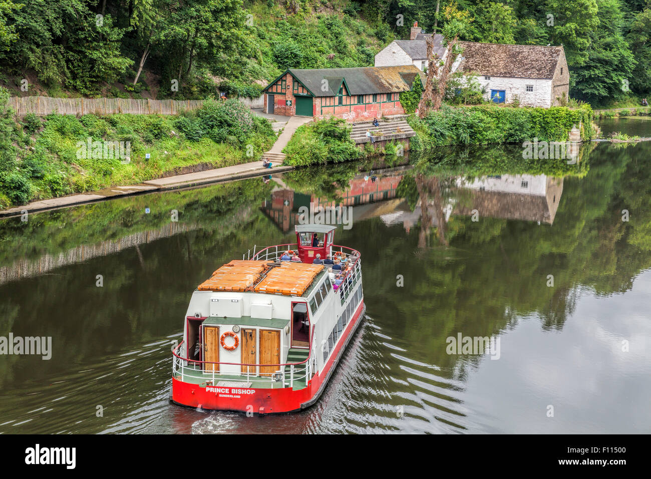 Pleasure boat on the River Wear in Durham turns as it reaches the weir taken from Prebends Bridge Stock Photo