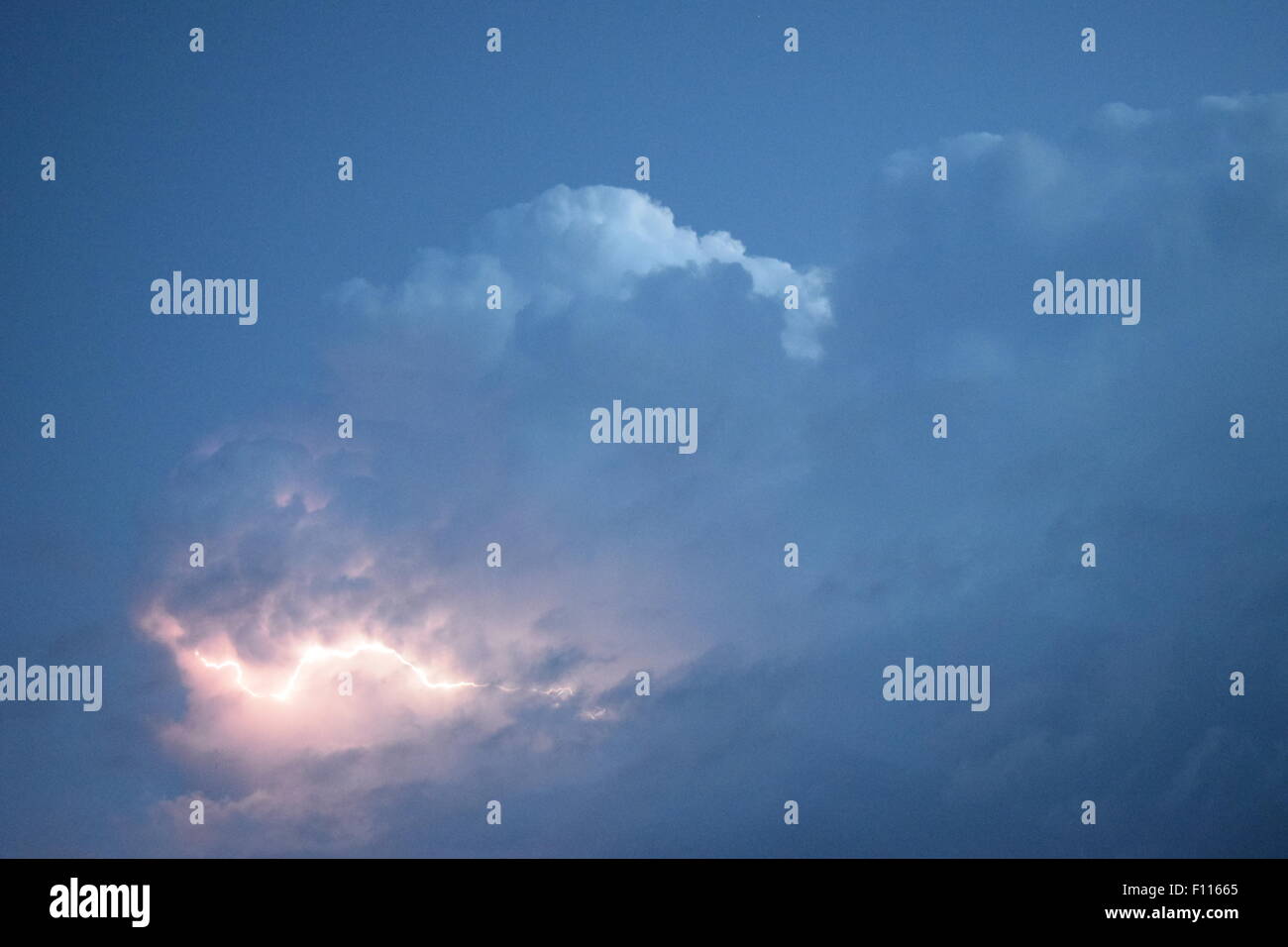 Lightnings in storm clouds. Peals of a thunder and the sparkling ...