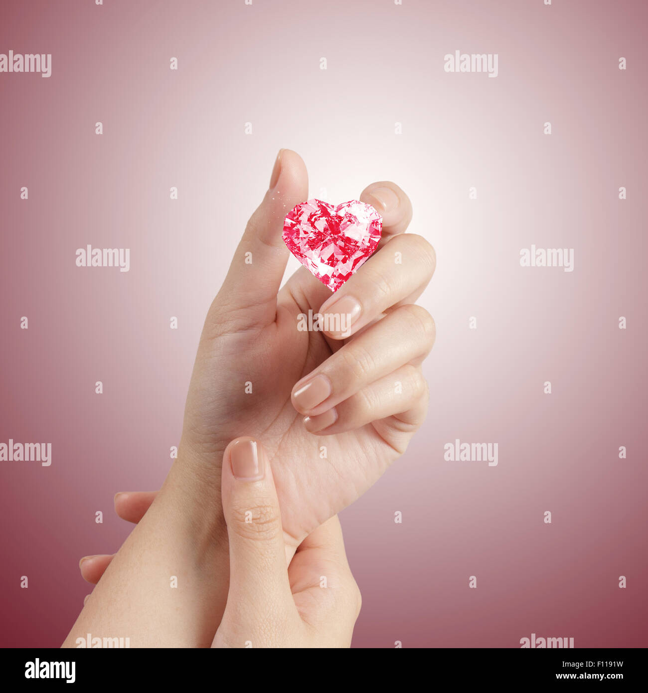 hand holding 3d red heart shape of diamond Stock Photo