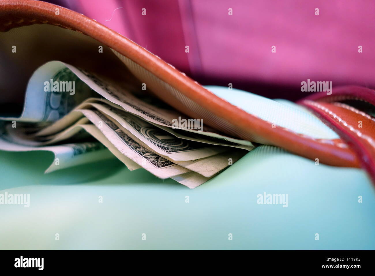Money peeking out of a bag Stock Photo - Alamy