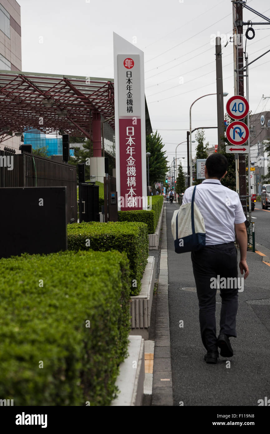 A man walks pass the Japan Pension Service (JPS) building in Tokyo, Japan on August 25, 2015. In May hackers who tapped into the pension system stole personal data for 1.25 million people with a classic ploy called a ''targeted email attack'' disguised as a health ministry document. According to the JPS, a total of 124 targeted e-mails carrying a virus from May 8 to 20 were opened, causing 31 computers to be infected and the leak of the personal data of 1.25 million people. © Rodrigo Reyes Marin/AFLO/Alamy Live News Stock Photo