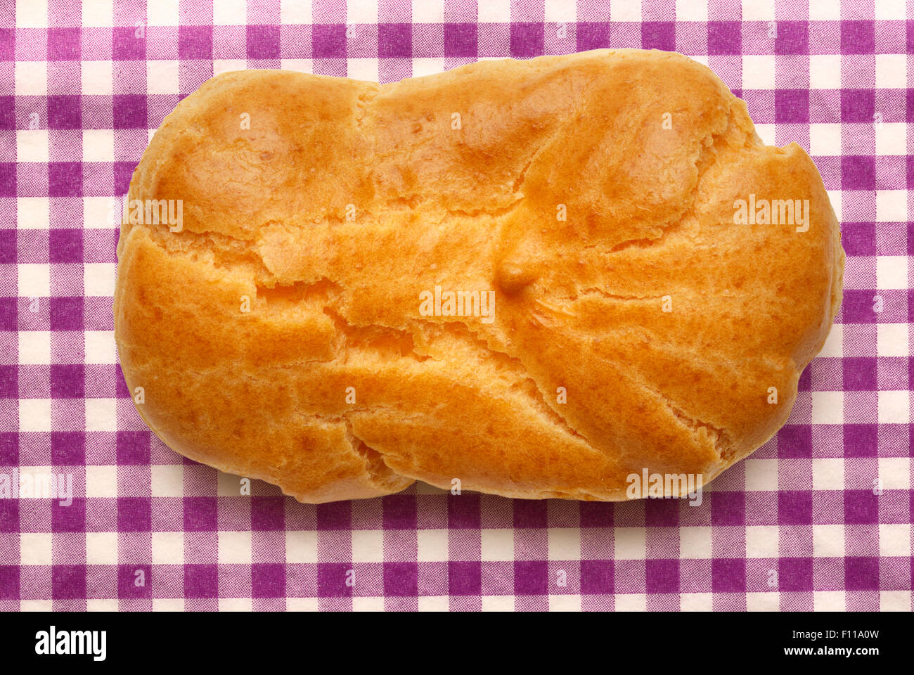 Pastry dough eclair with vanilla cream inside Stock Photo