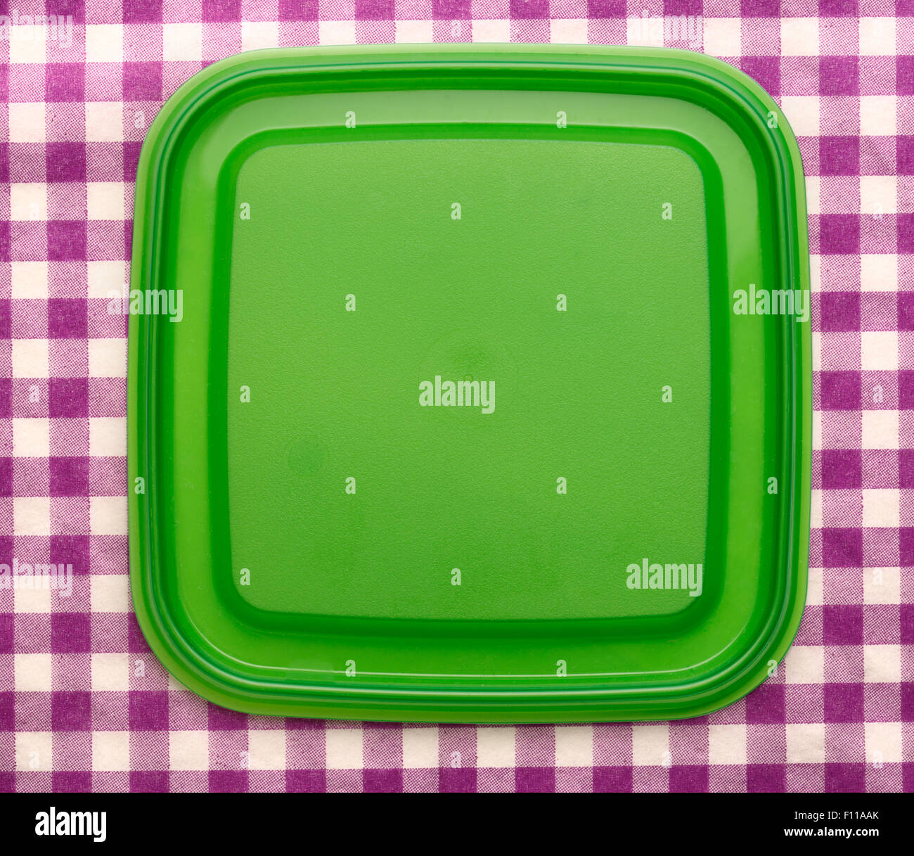 Green square plastic cover on background closeup Stock Photo