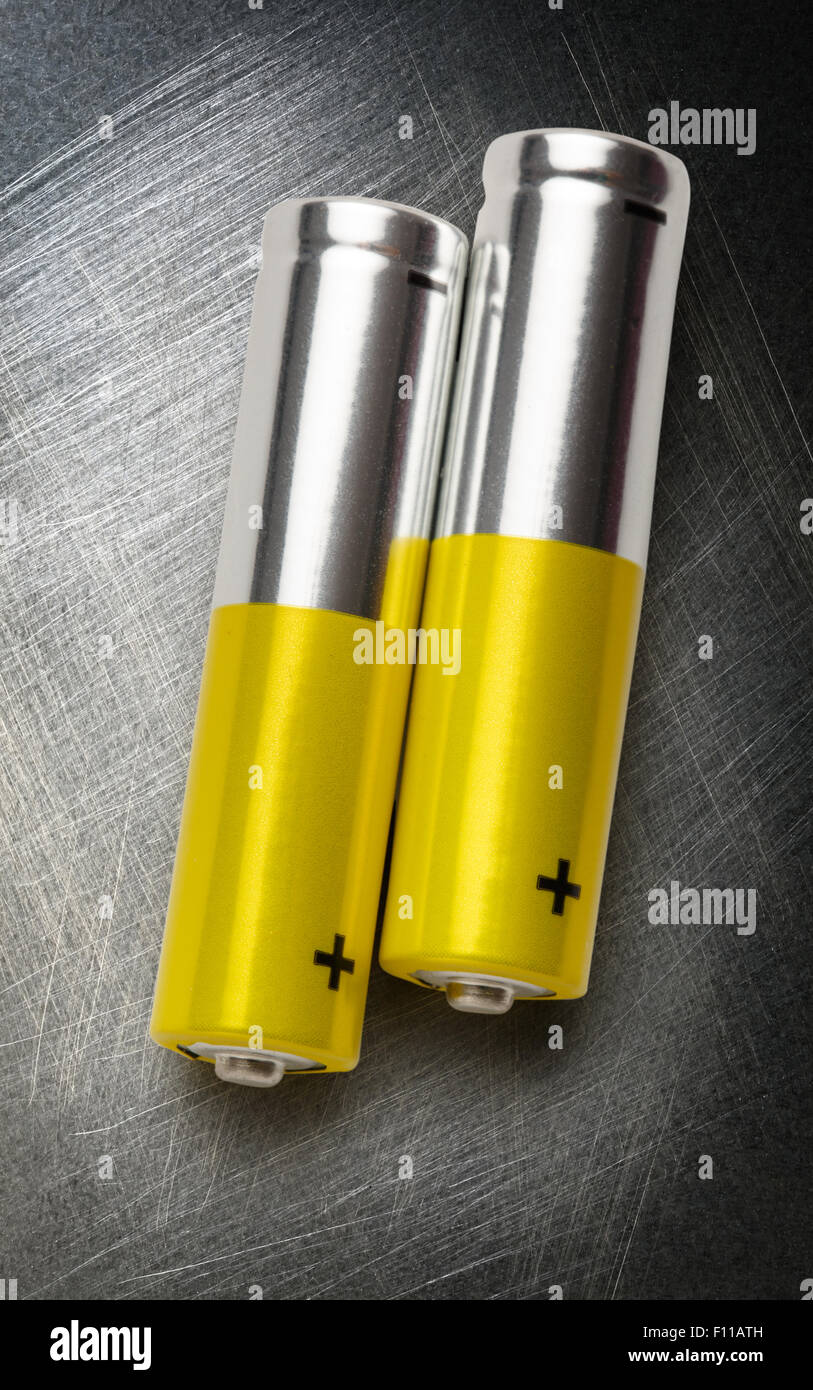 Two batteries with plus sign visible in closeup Stock Photo Alamy