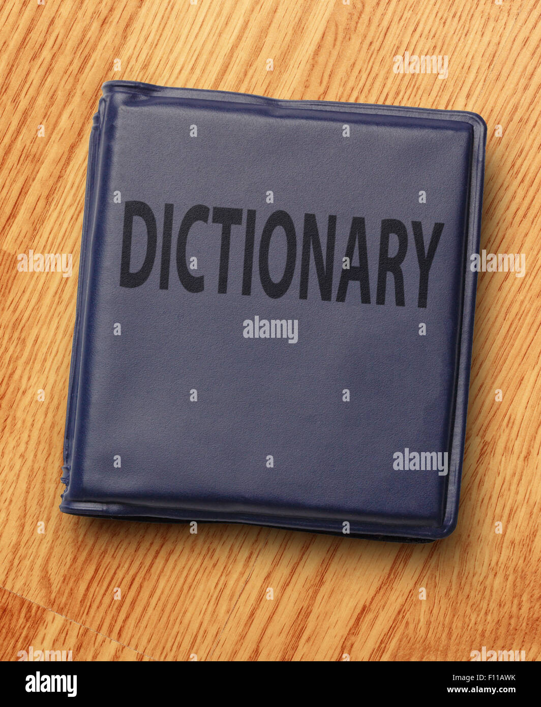Dark blue dictionary on the wooden background Stock Photo