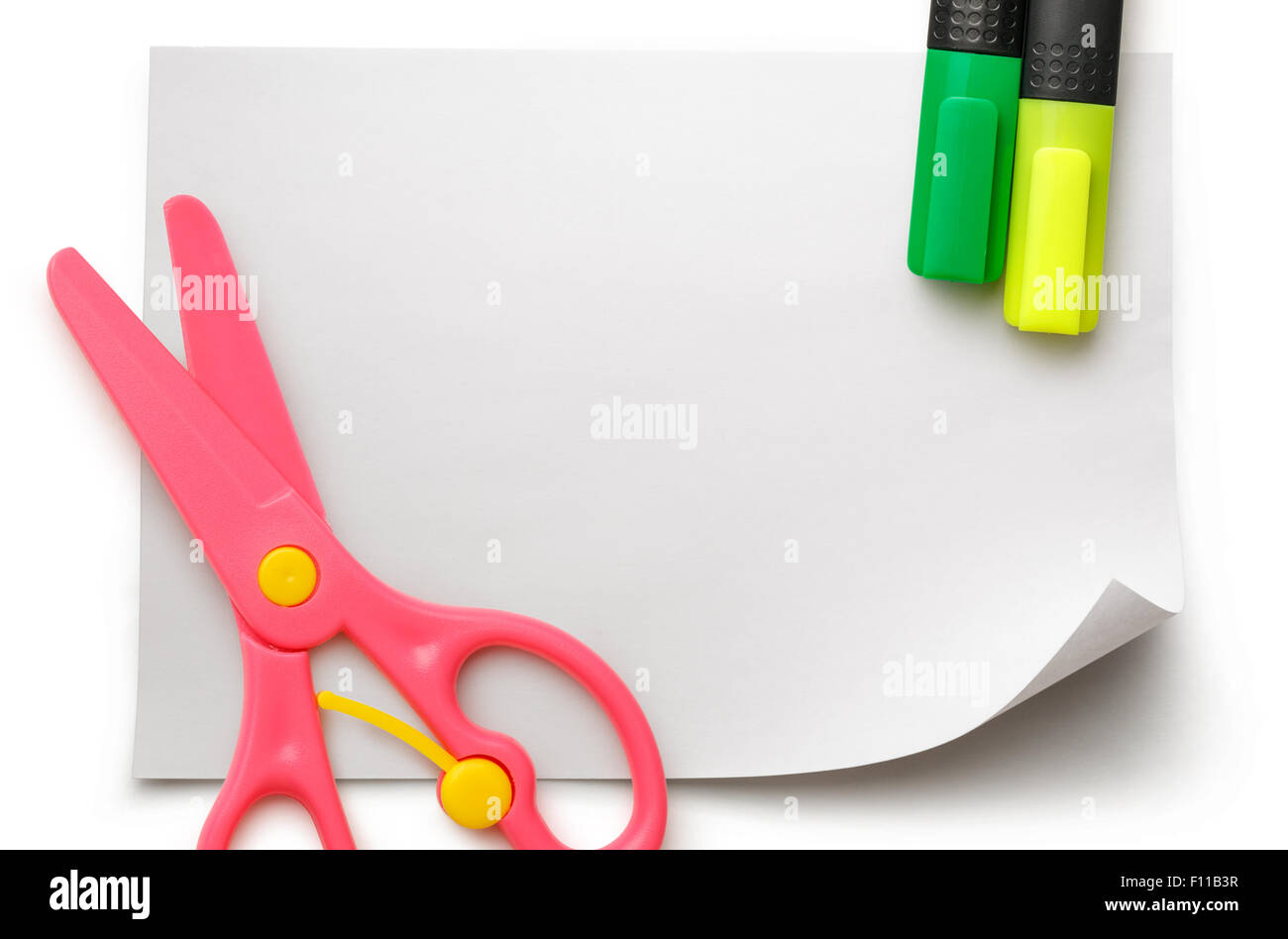Safe scissors and markers on blank white piece of paper Stock Photo