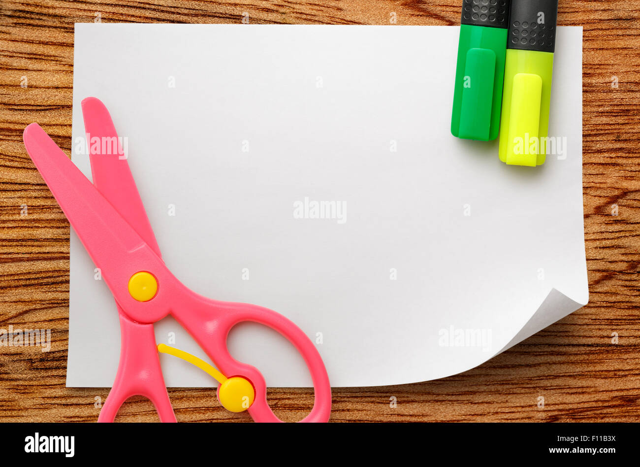 multicolored pastel construction paper fanned out with a pair of child's  pink scissors, isolated on white Stock Photo - Alamy