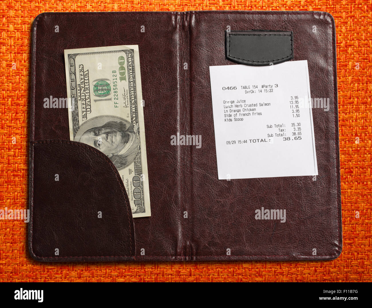 Open check folder with bill and money Stock Photo - Alamy