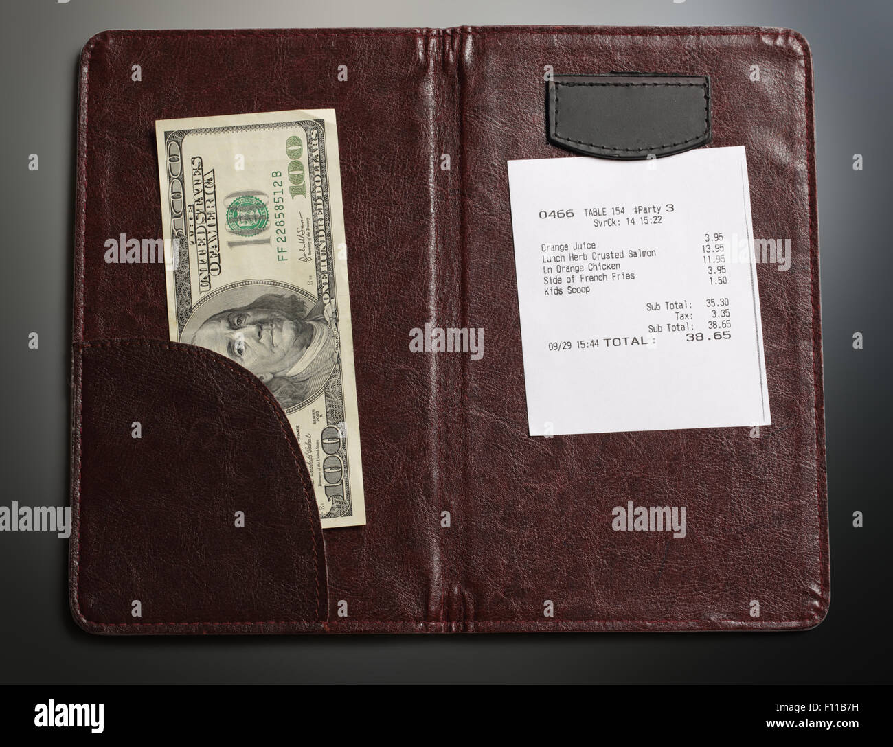Open check folder with bill and money Stock Photo