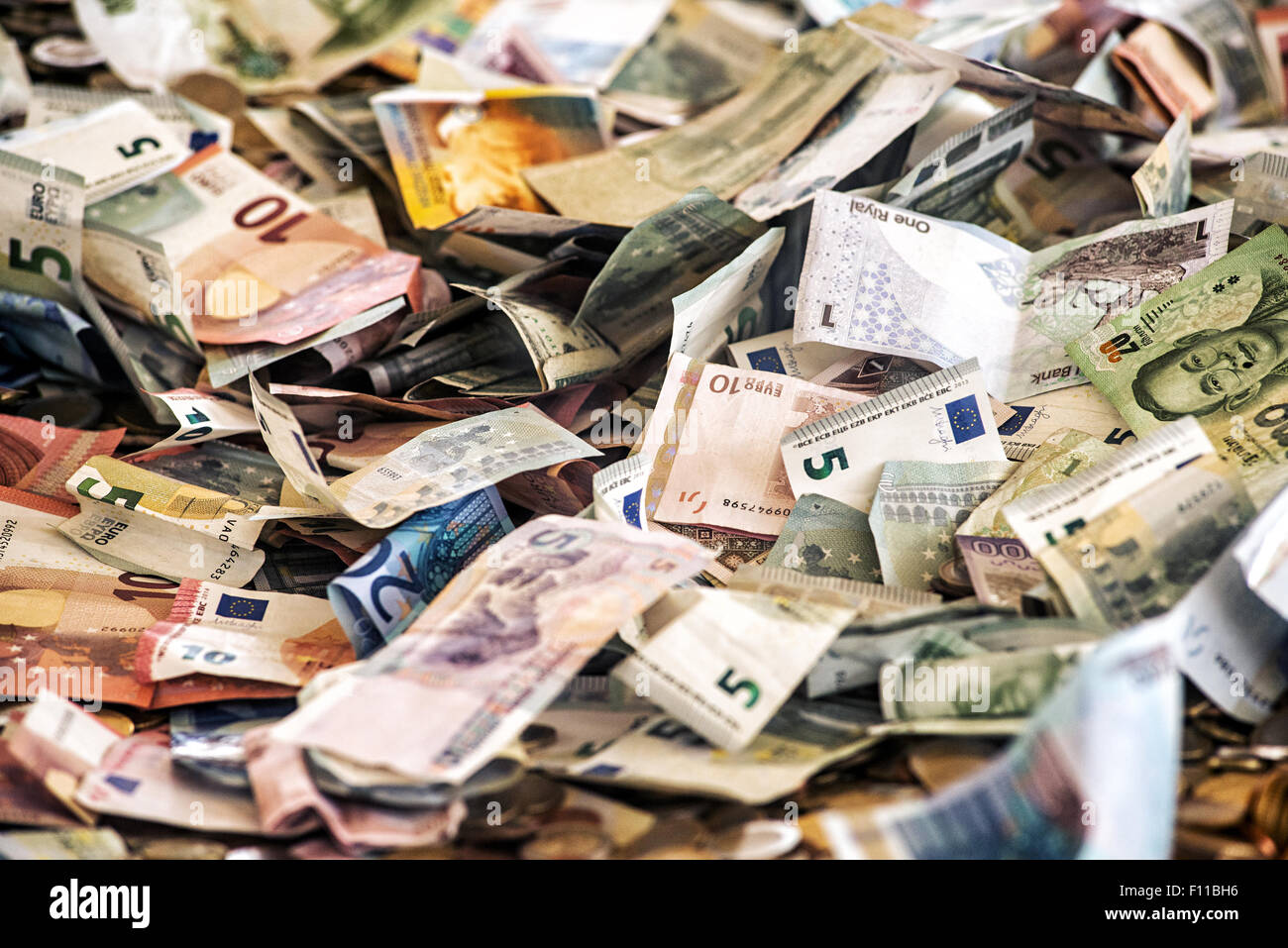 Money background of a heap of assorted banknotes in different currencies Stock Photo