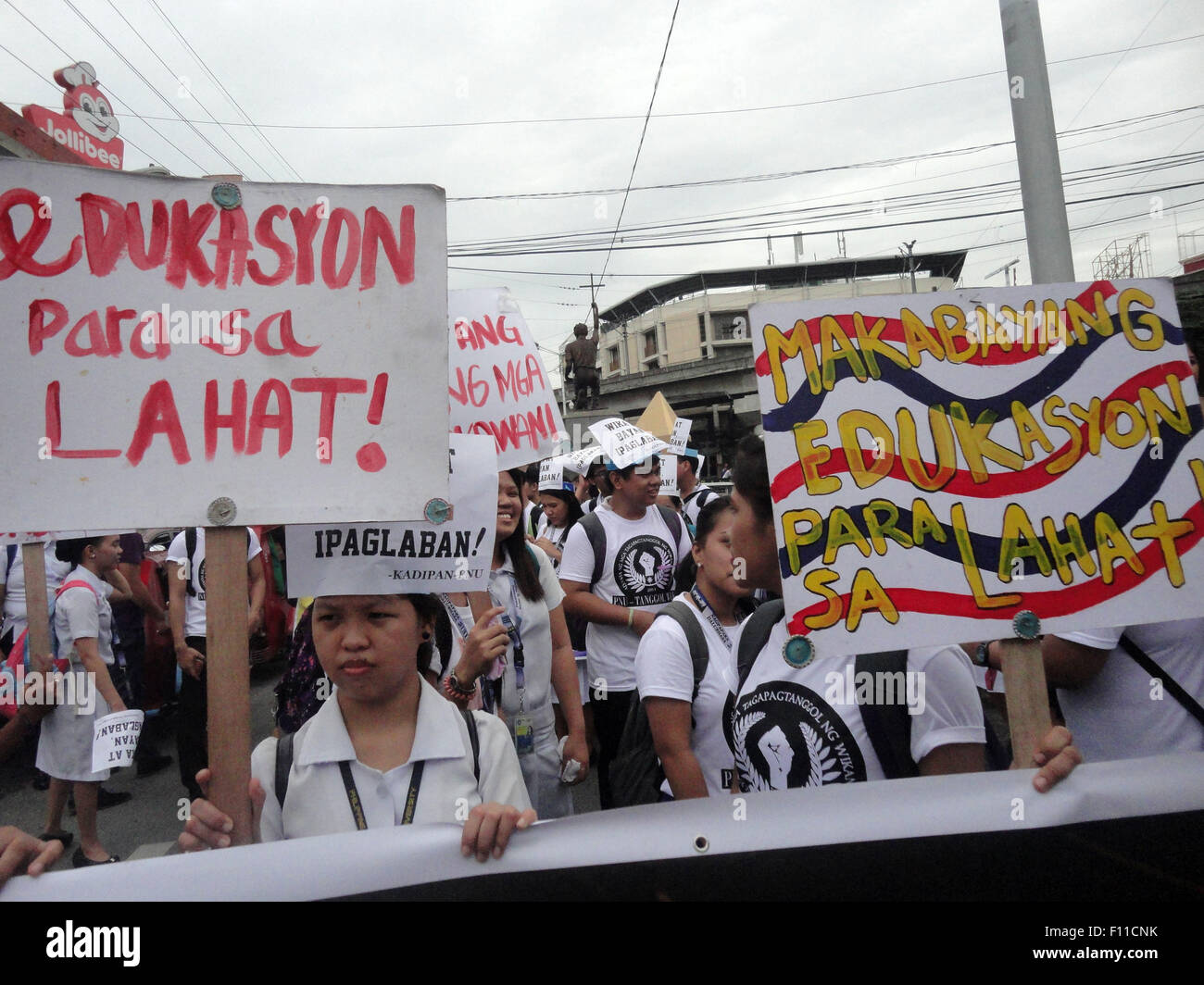 Filipino student activists hold placards bearing the messages