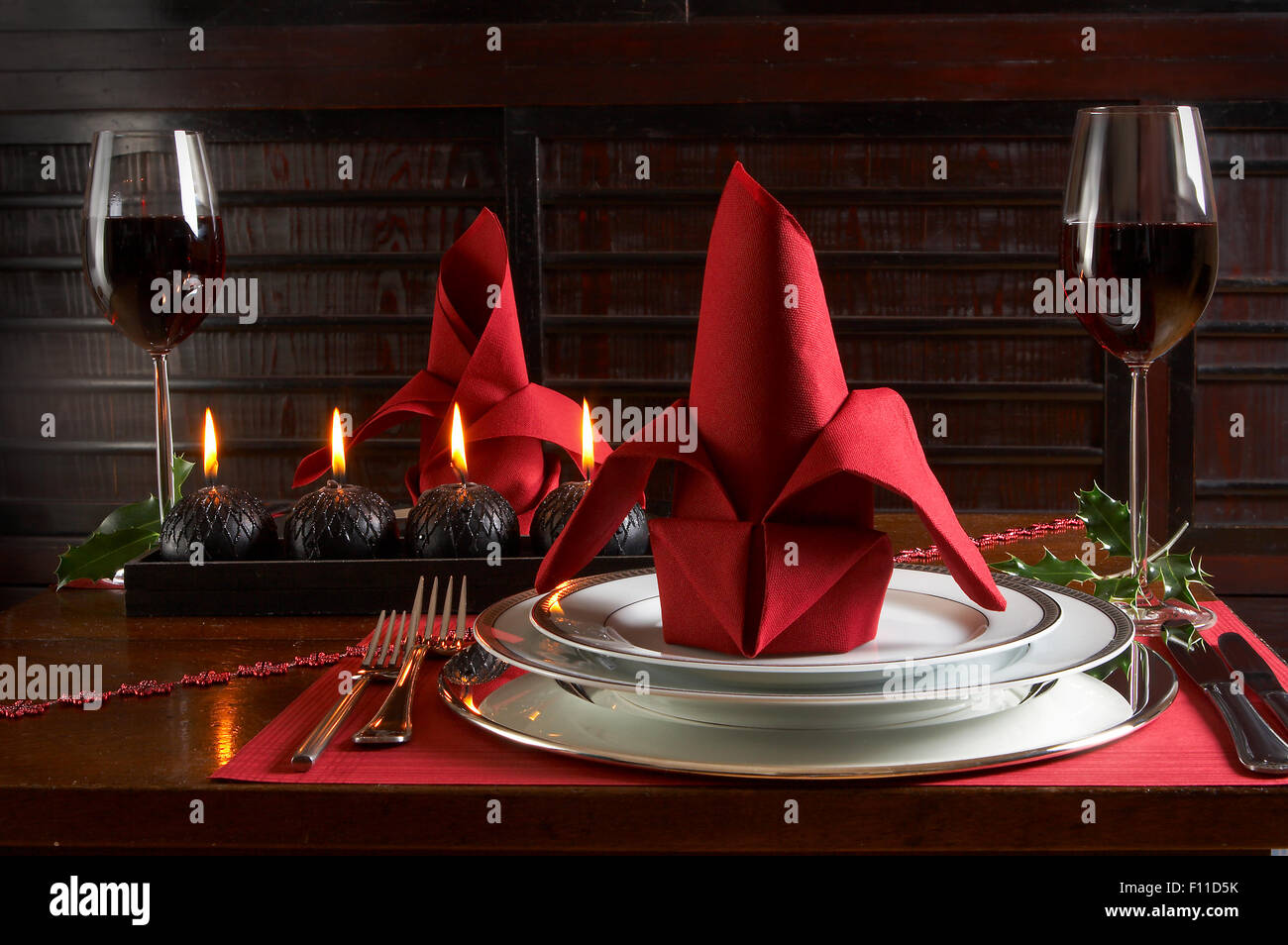Christmas dinner table with red accents of placemats and napkins Stock