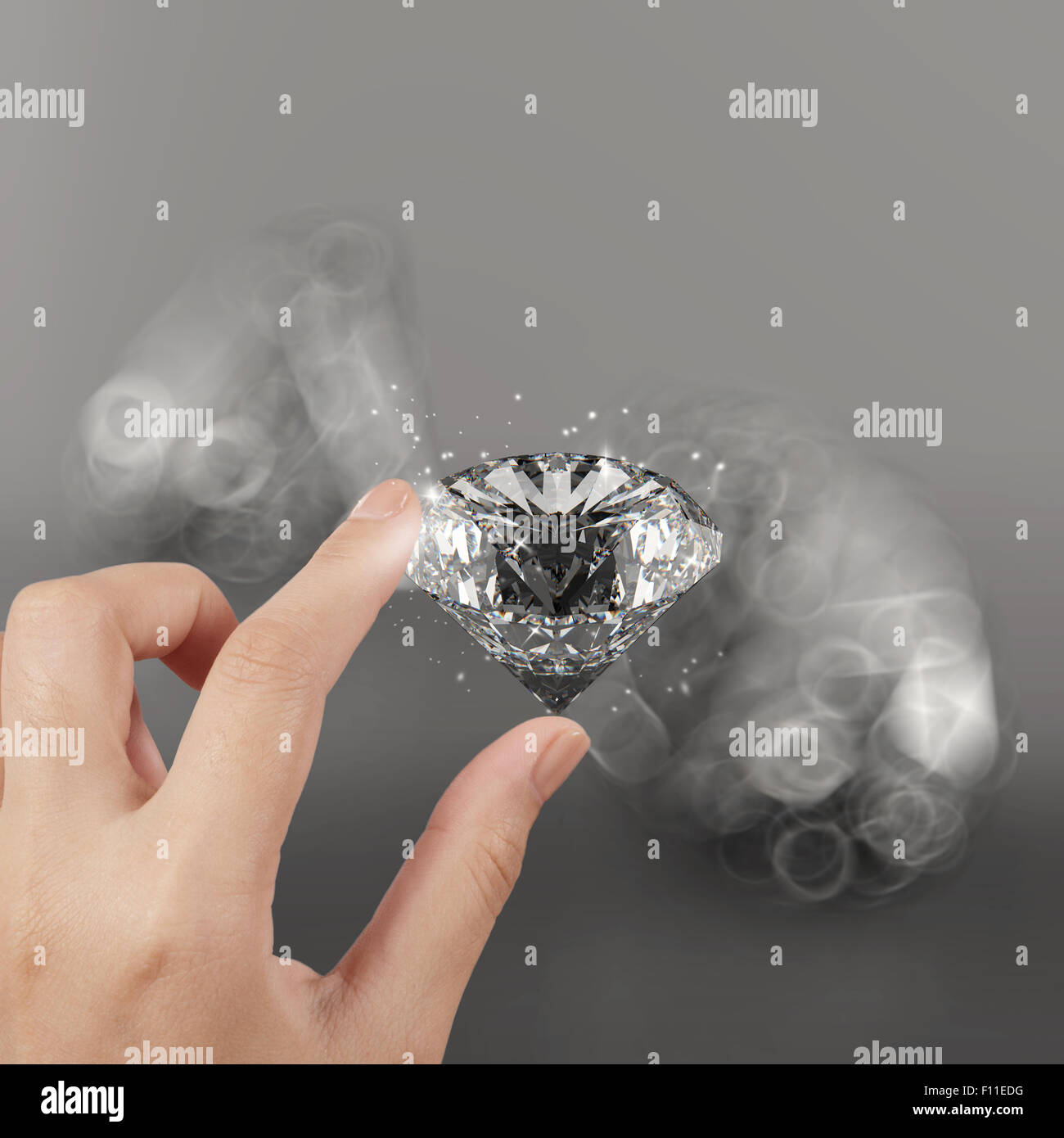 hand holding 3d diamond over grey background Stock Photo