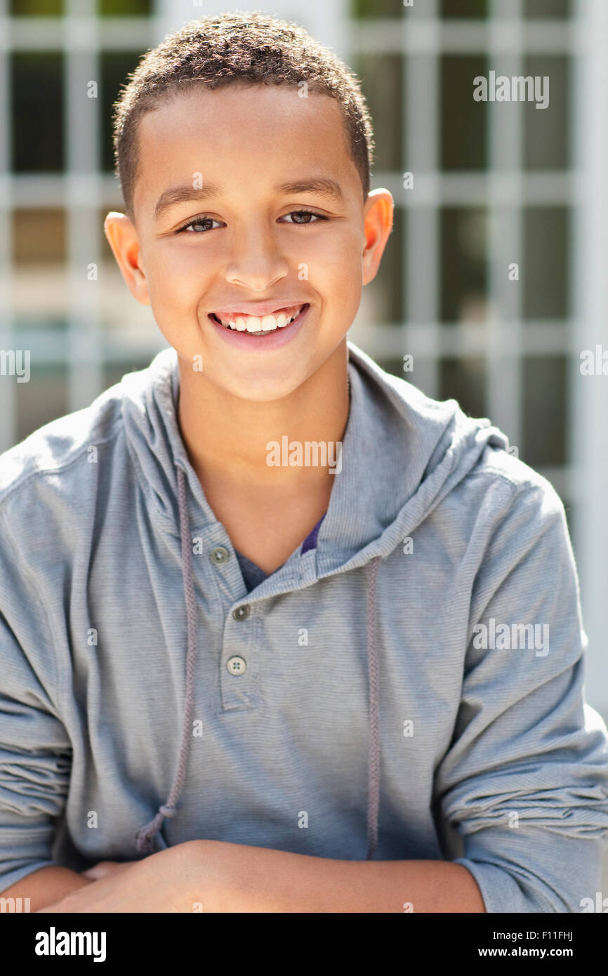 Close up of mixed race boy smiling outdoors Stock Photo