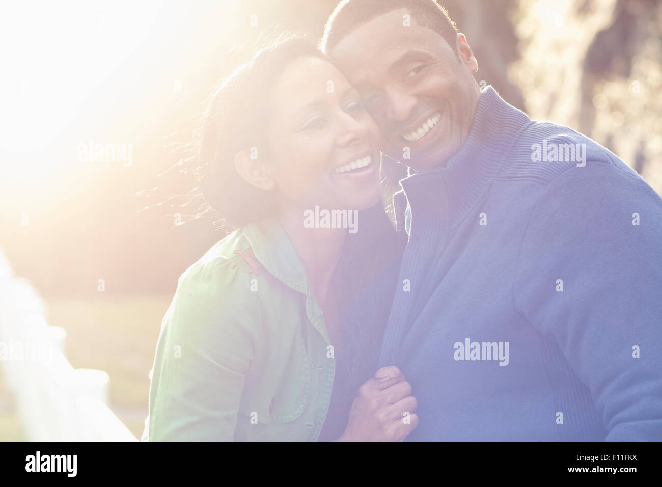 Smiling couple hugging outdoors Stock Photo