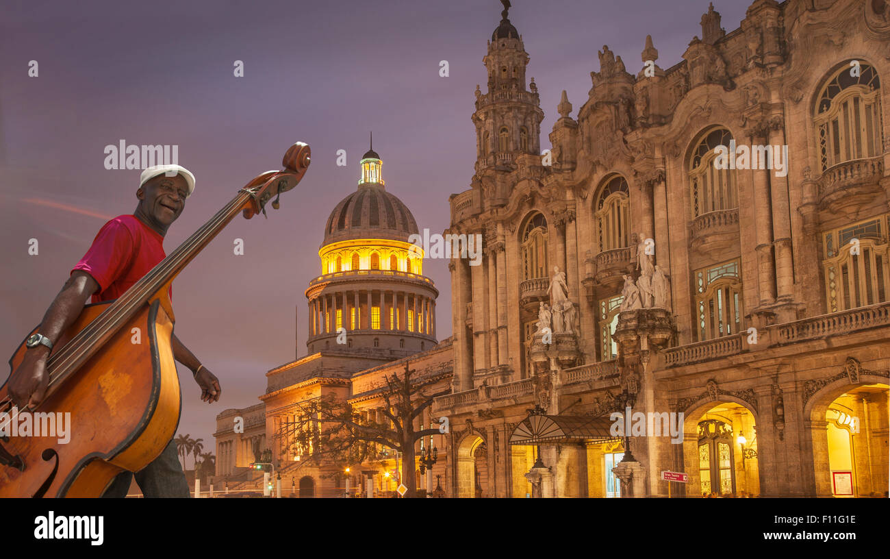 Hispanic musician carrying upright bass in city, Havana, Cuba Stock Photo