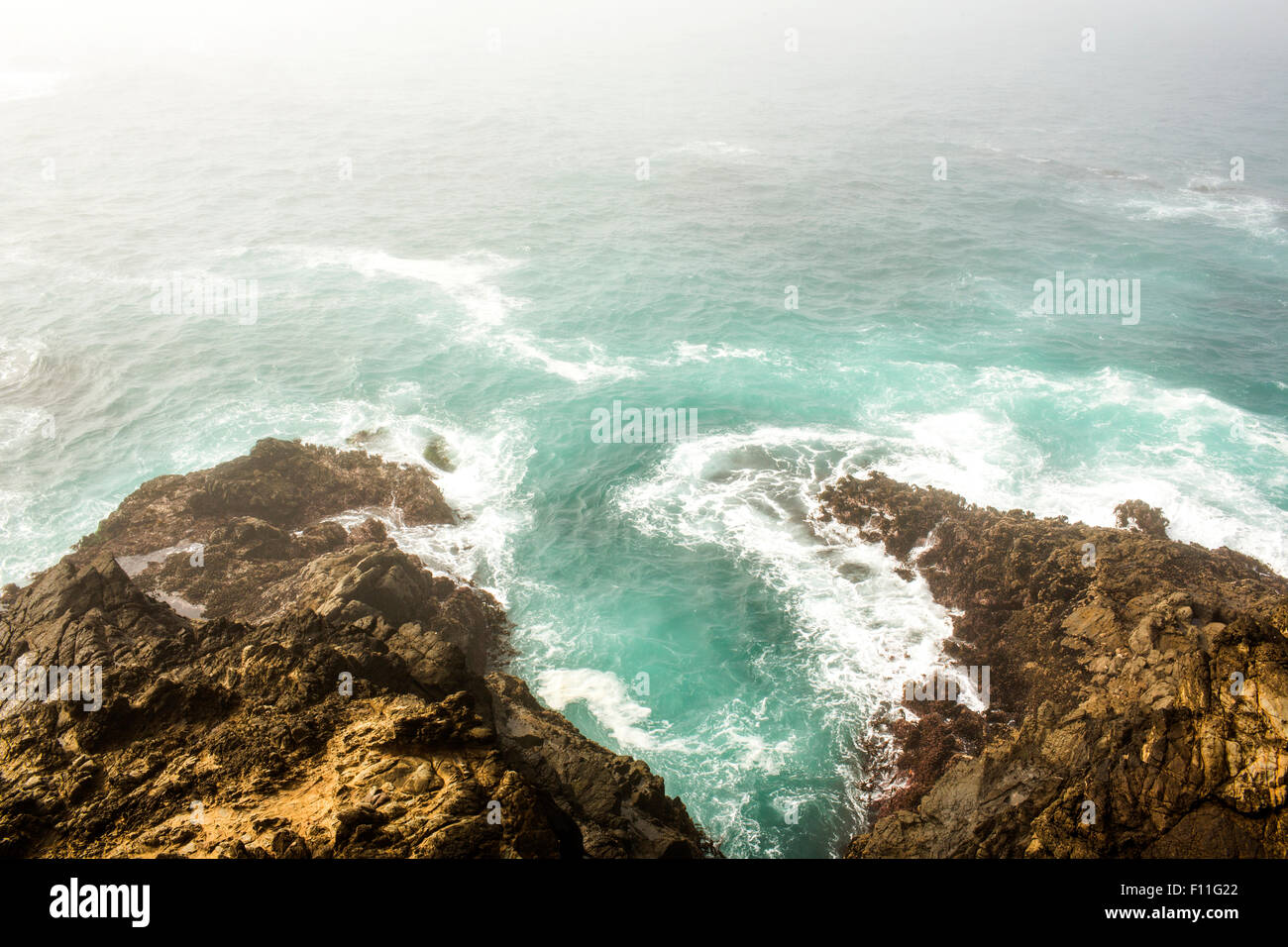 High angle view of ocean waves crashing on cliffs Stock Photo