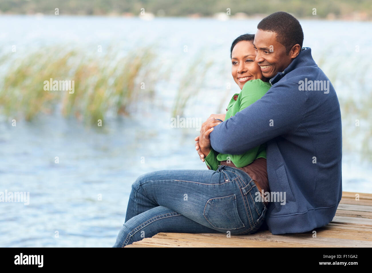 Smiling couple hugging on dock Stock Photo