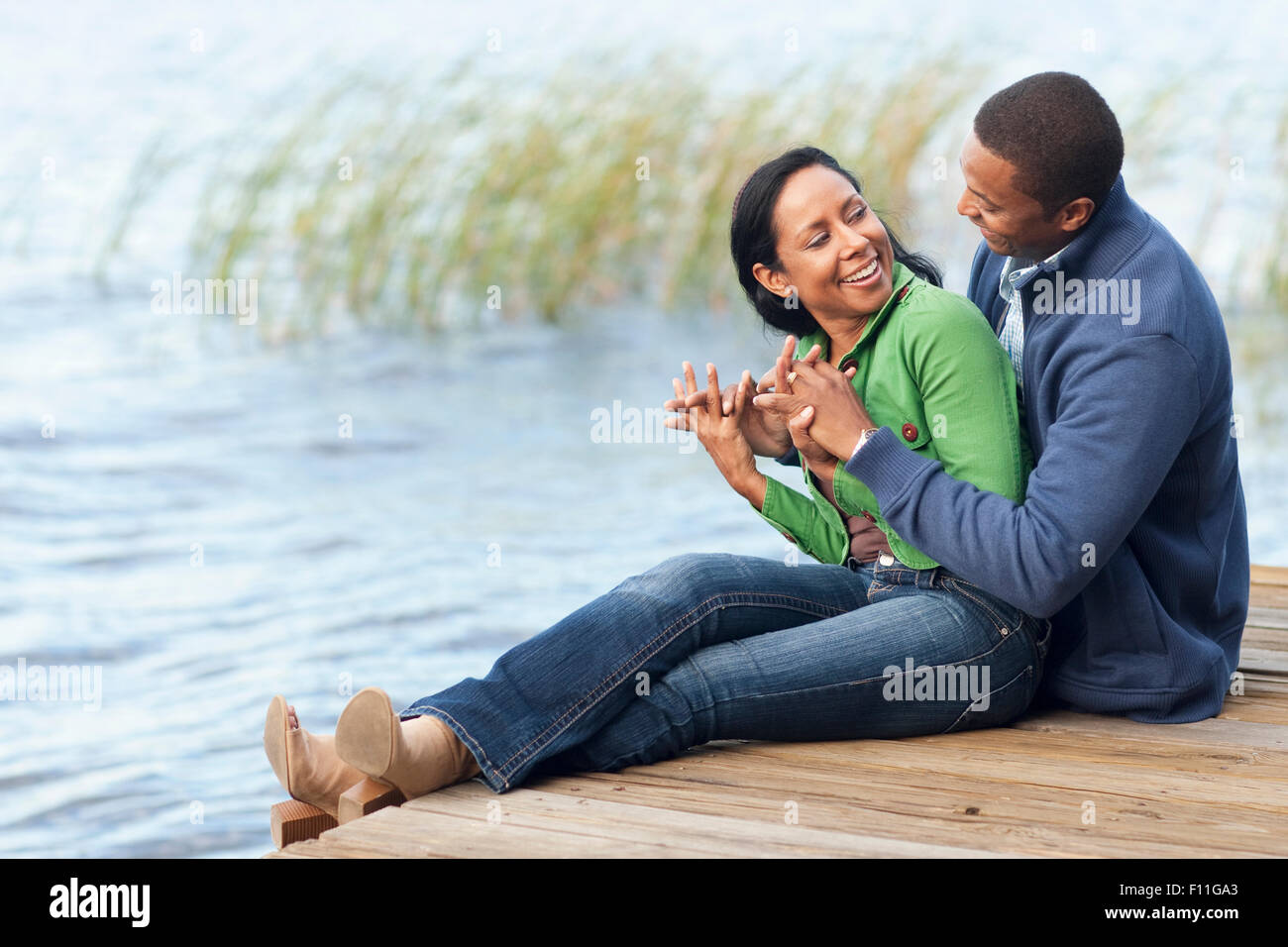 Smiling couple hugging at dock Stock Photo